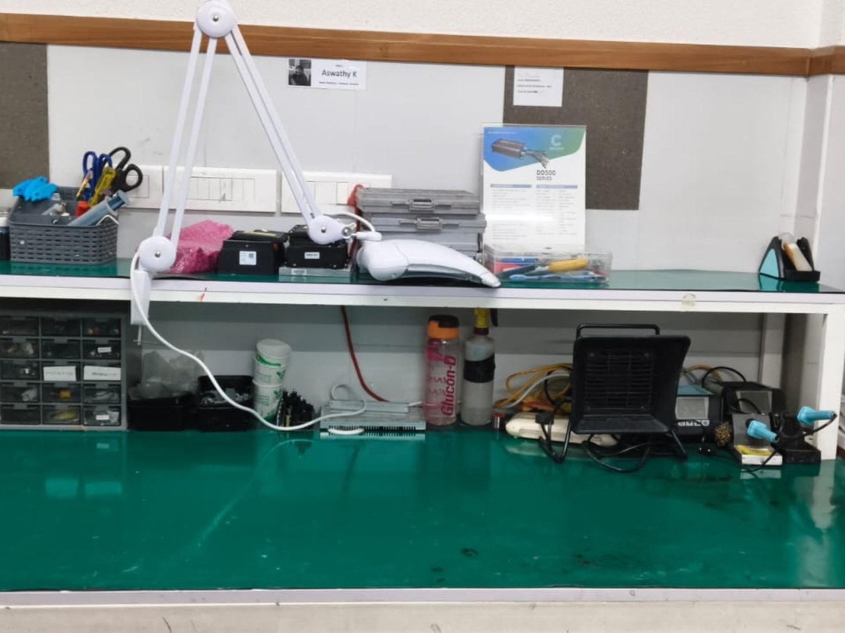 ESD-safe electronics bench with soldering station, magnifier lamp and controller units